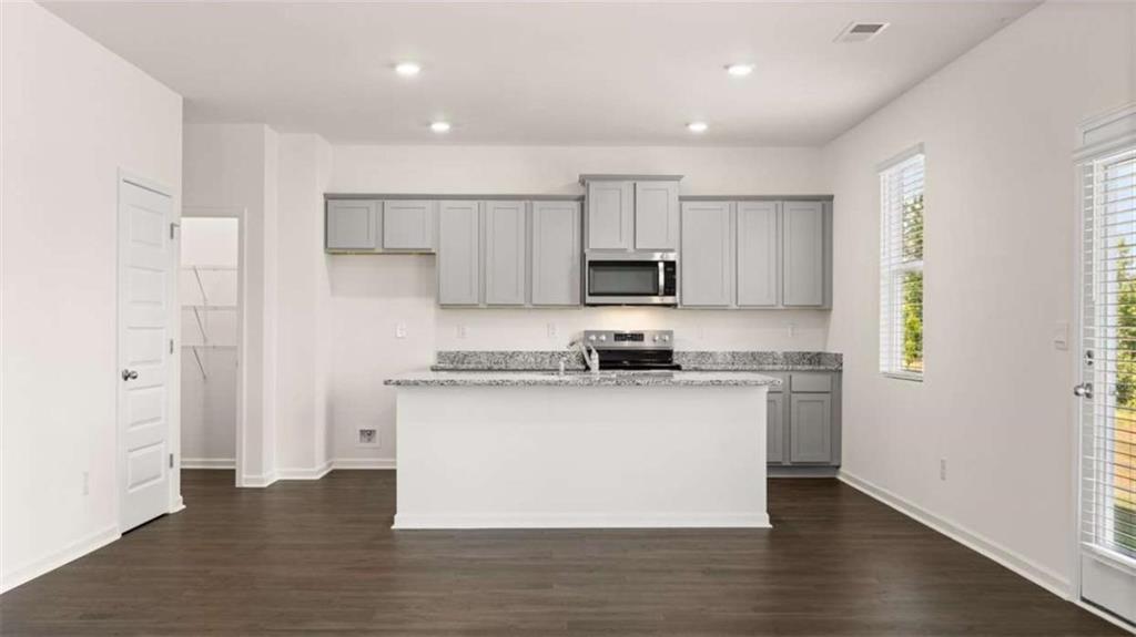 178 Aster Avenue Locust Grove, GA 30248 - Photo 11 of 36 a kitchen with stainless steel appliances a sink stove and refrigerator