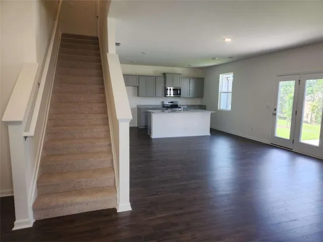 a view of a kitchen with furniture and wooden floor