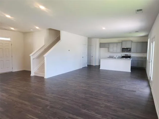 a view of a kitchen with a sink and a refrigerator