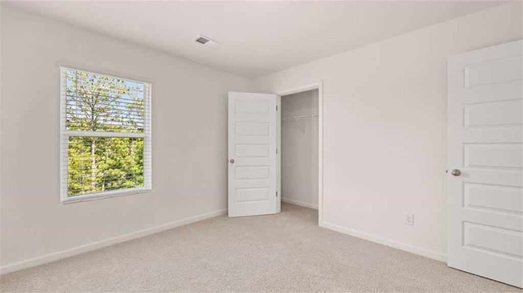 178 Aster Avenue Locust Grove, GA 30248 - Photo 28 of 36 an empty room with windows