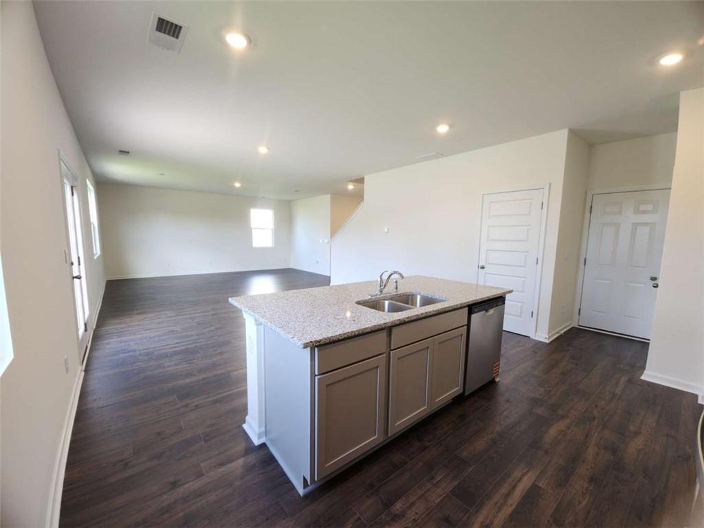 178 Aster Avenue Locust Grove, GA 30248 - Photo 31 of 36 a kitchen with a sink cabinets and wooden floor