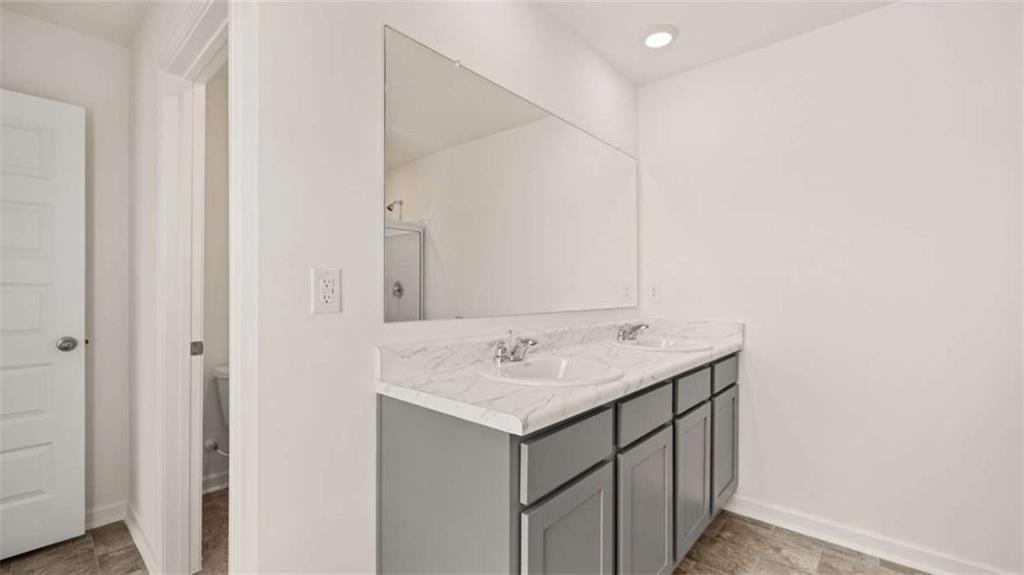 178 Aster Avenue Locust Grove, GA 30248 - Photo 32 of 36 a bathroom with a sink and a mirror