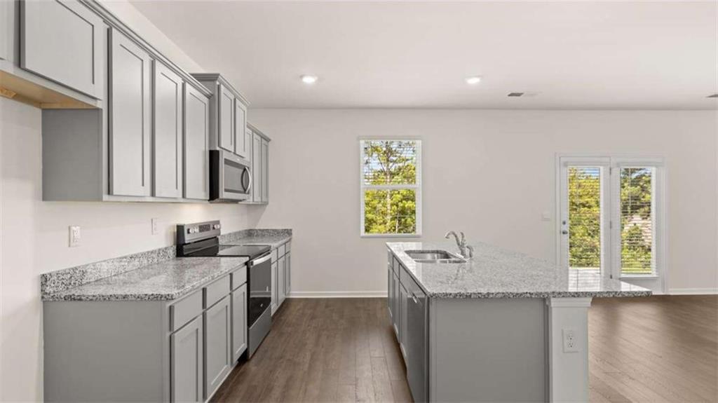 178 Aster Avenue Locust Grove, GA 30248 - Photo 10 of 36 a kitchen with a sink stove and microwave