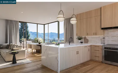 a open kitchen with stainless steel appliances granite countertop a sink dishwasher a stove and white cabinets with wooden floor