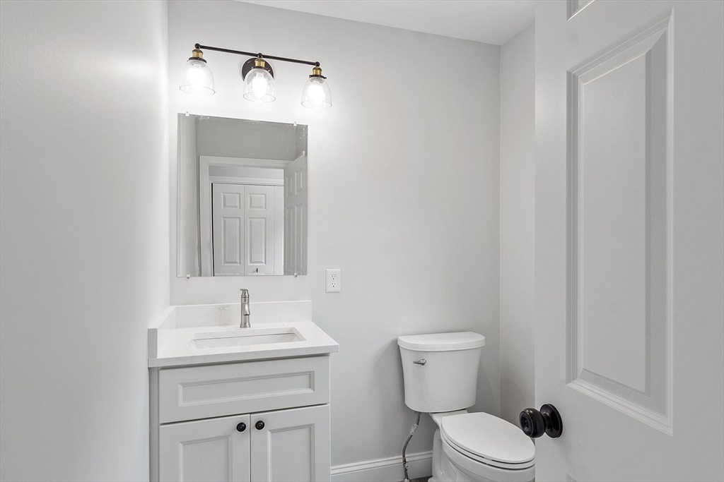 572 Pleasant Street Athol, MA 01331 - Photo 12 of 32 a bathroom with a toilet sink and mirror