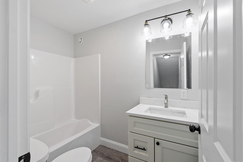 572 Pleasant Street Athol, MA 01331 - Photo 18 of 32 a bathroom with a sink a toilet and shower