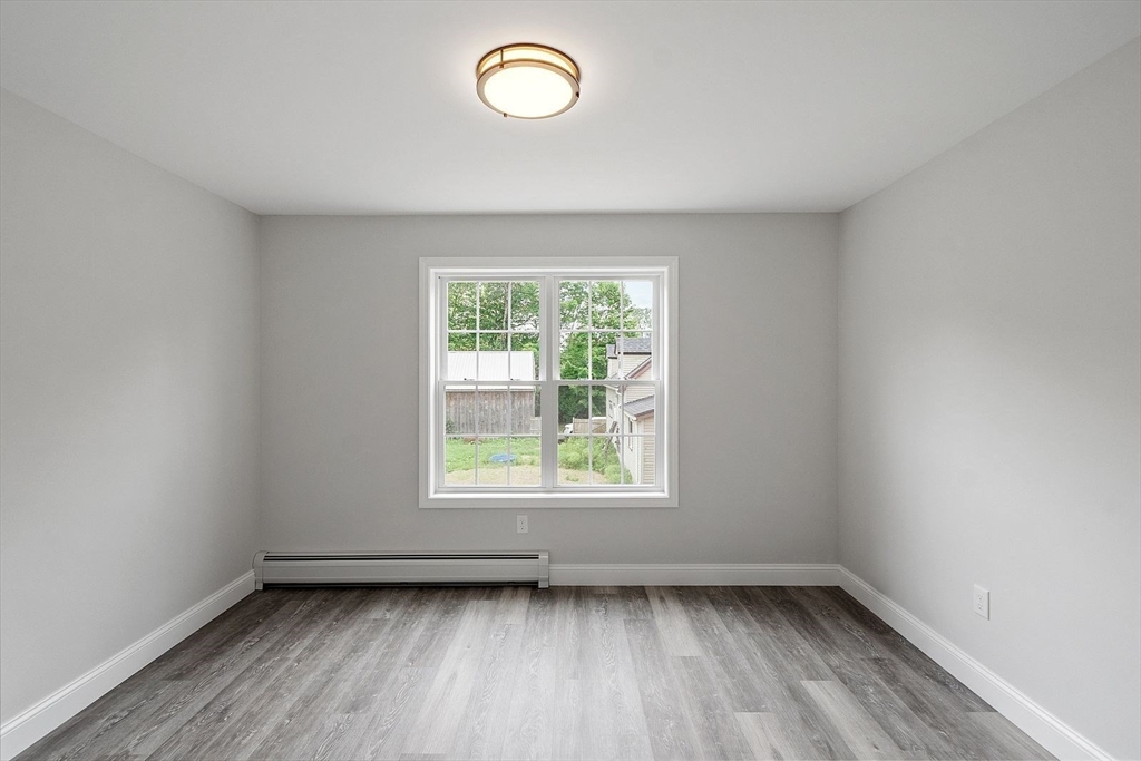 572 Pleasant Street Athol, MA 01331 - Photo 19 of 32 an empty room with wooden floor and windows