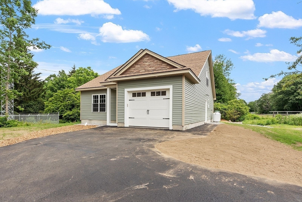 572 Pleasant Street Athol, MA 01331 - Photo 2 of 32 a front view of a house with a yard and garage