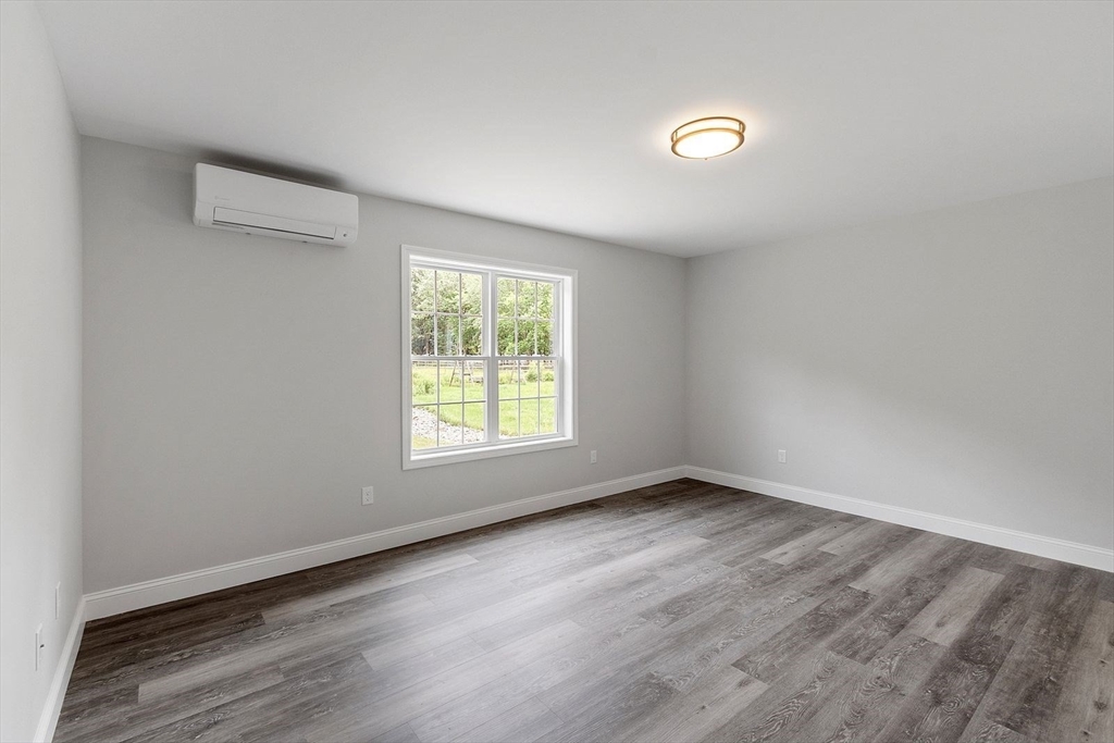572 Pleasant Street Athol, MA 01331 - Photo 22 of 32 an empty room with wooden floor and windows