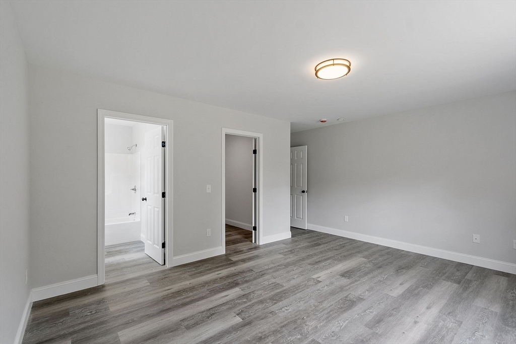 572 Pleasant Street Athol, MA 01331 - Photo 23 of 32 a view of an empty room with wooden floor and closet