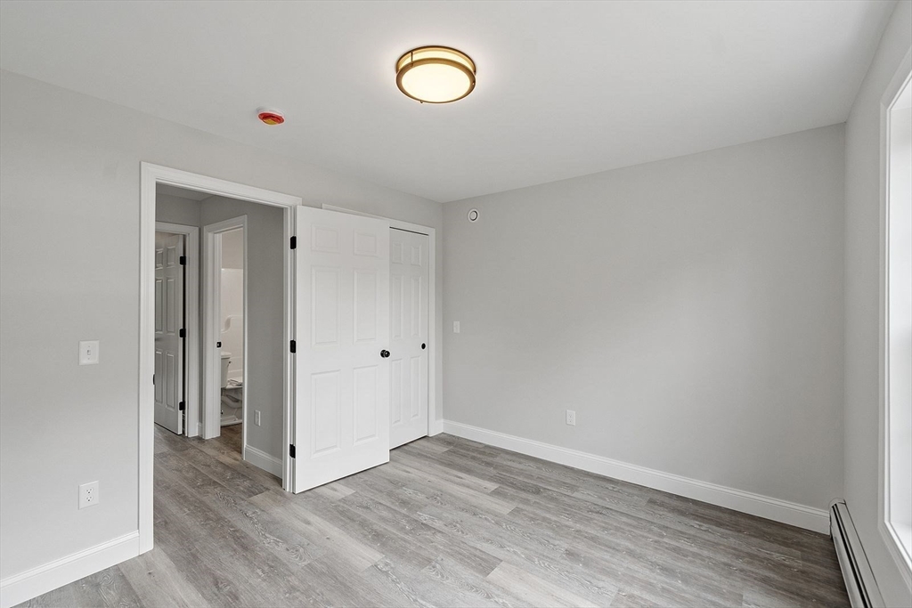 572 Pleasant Street Athol, MA 01331 - Photo 24 of 32 a view of a room with wooden floor and window