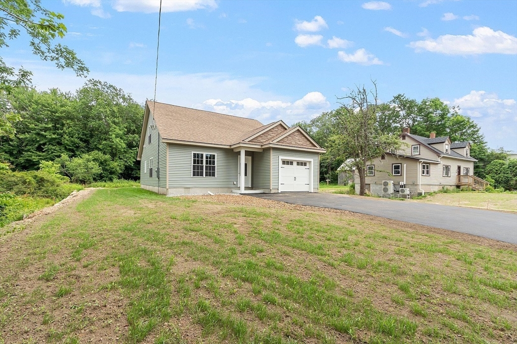 572 Pleasant Street Athol, MA 01331 - Photo 3 of 32 a front view of a house with yard and green space