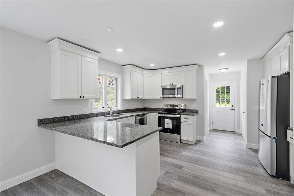 572 Pleasant Street Athol, MA 01331 - Photo 5 of 32 a kitchen with stainless steel appliances granite countertop a refrigerator a sink dishwasher a stove with wooden floors
