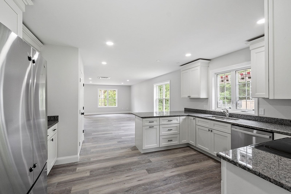 572 Pleasant Street Athol, MA 01331 - Photo 7 of 32 a large kitchen with cabinets and stainless steel appliances
