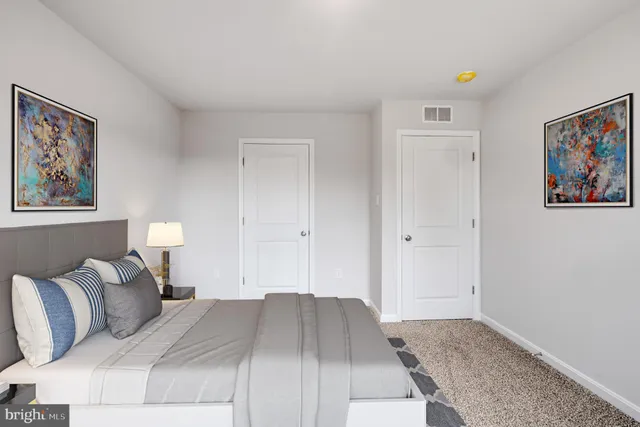 a bed room with a bed and a painting on the wall