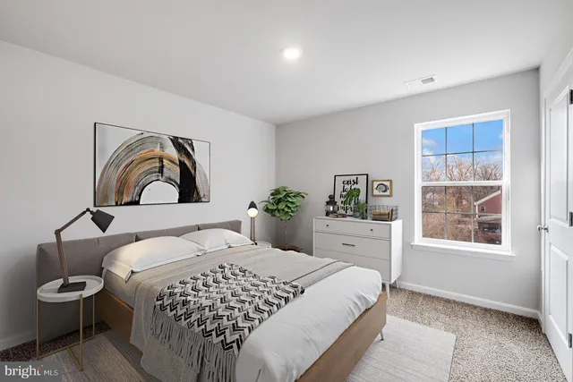 a bedroom with a large bed and a window