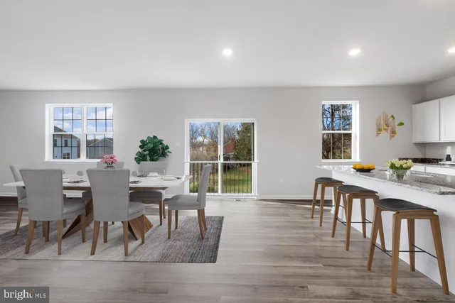a view of a dining room with furniture window and wooden floor