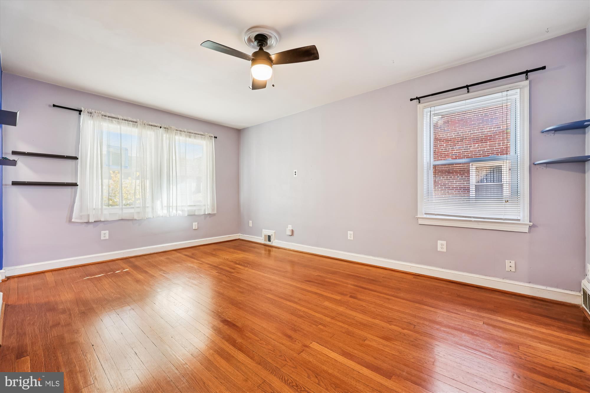 4808 Fort Totten Drive Northeast Washington, DC 20011 - Photo 19 of 30 an empty room with wooden floor chandelier fan and windows