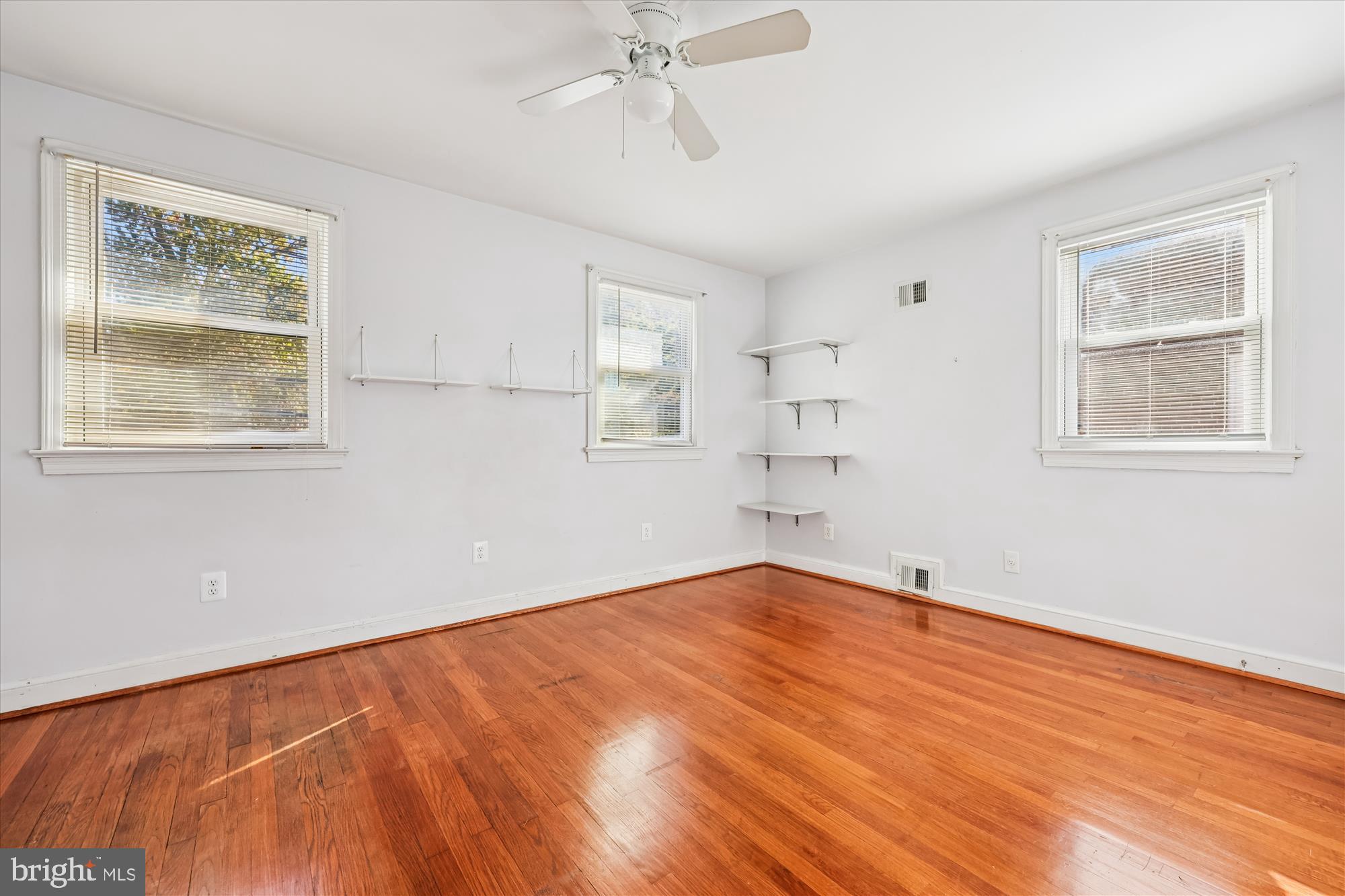 4808 Fort Totten Drive Northeast Washington, DC 20011 - Photo 20 of 30 a view of an empty room with a window and wooden floor