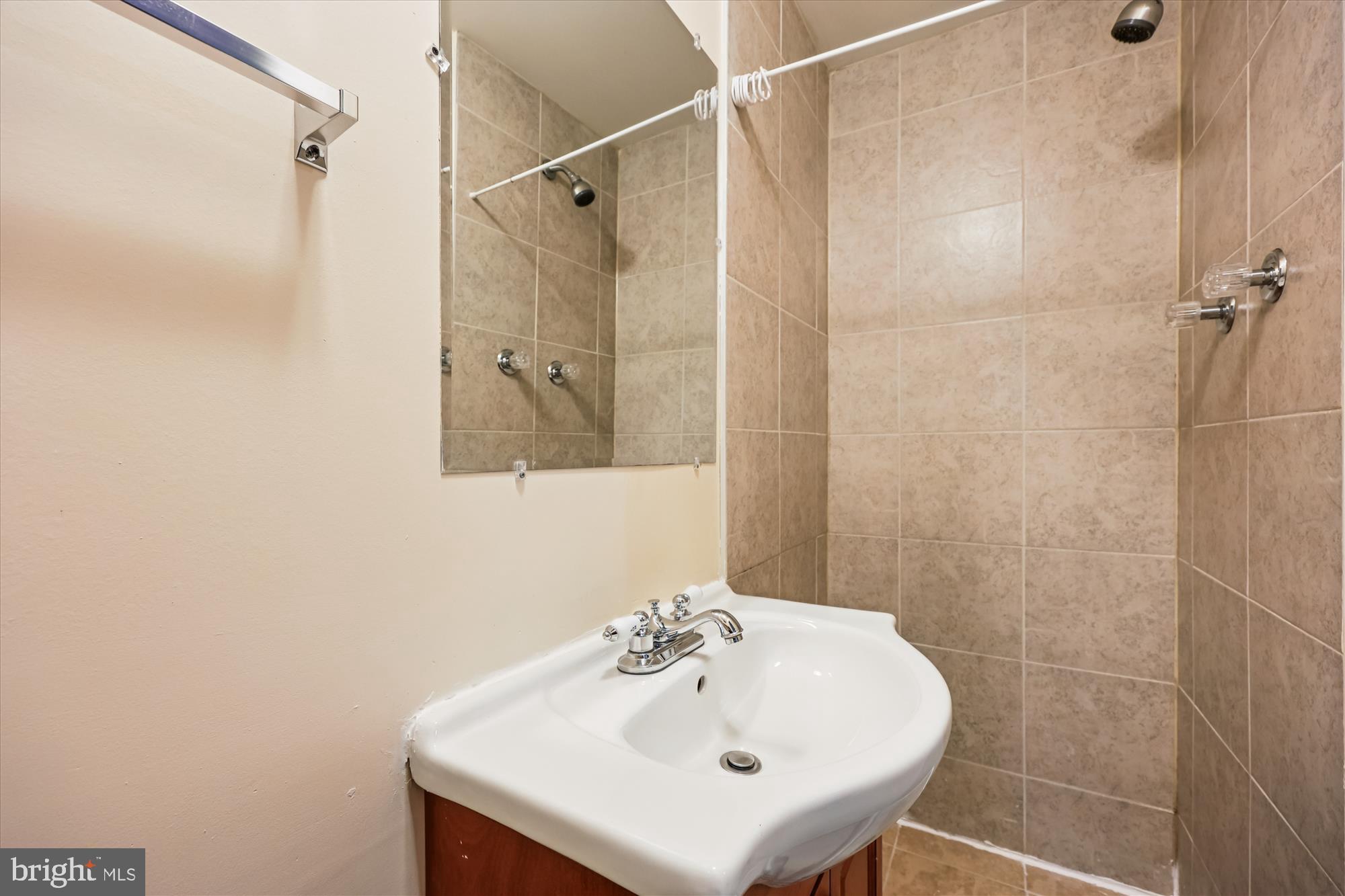 4808 Fort Totten Drive Northeast Washington, DC 20011 - Photo 25 of 30 a bathroom with a sink a shower and a mirror