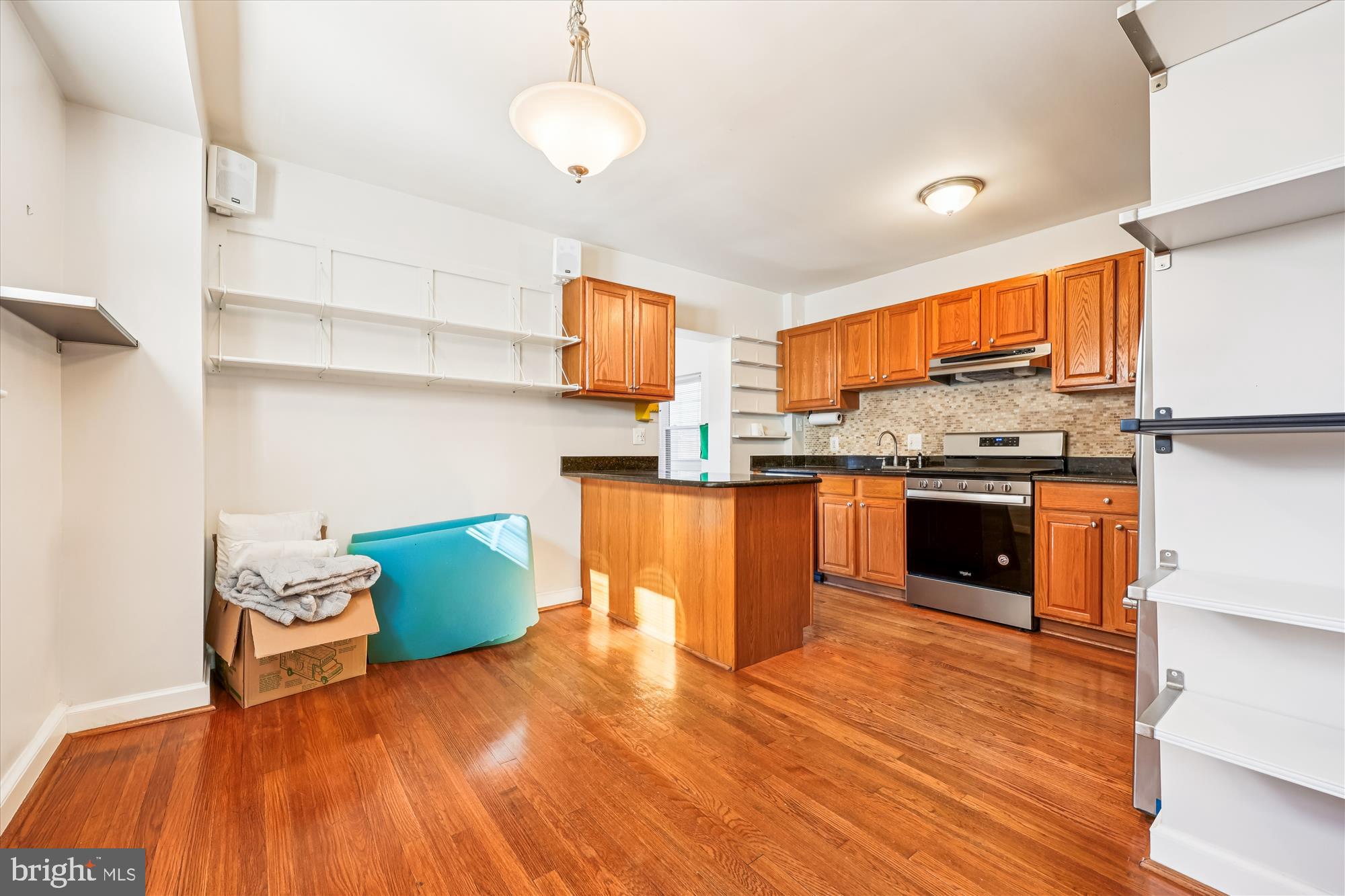 4808 Fort Totten Drive Northeast Washington, DC 20011 - Photo 7 of 30 a kitchen with stainless steel appliances wooden floors and a view of living room