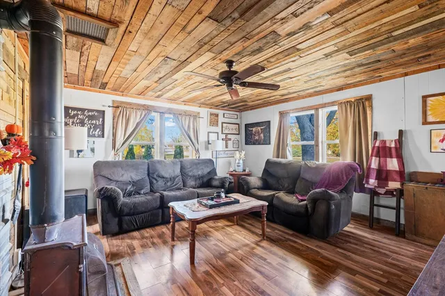 a living room with furniture a ceiling fan and a window