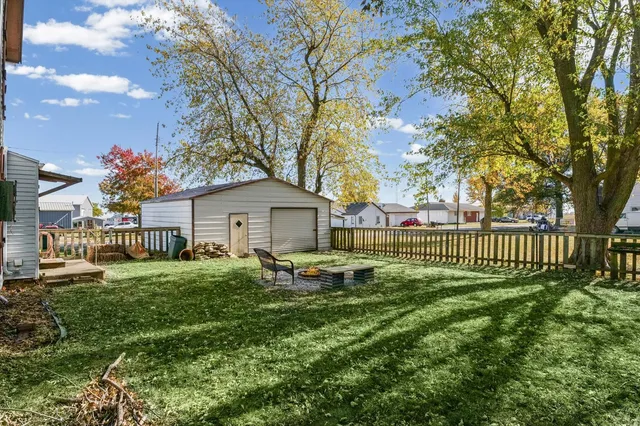 a view of a house with a big yard and a large tree
