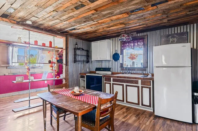 a kitchen with stainless steel appliances granite countertop a stove a refrigerator and a dining table