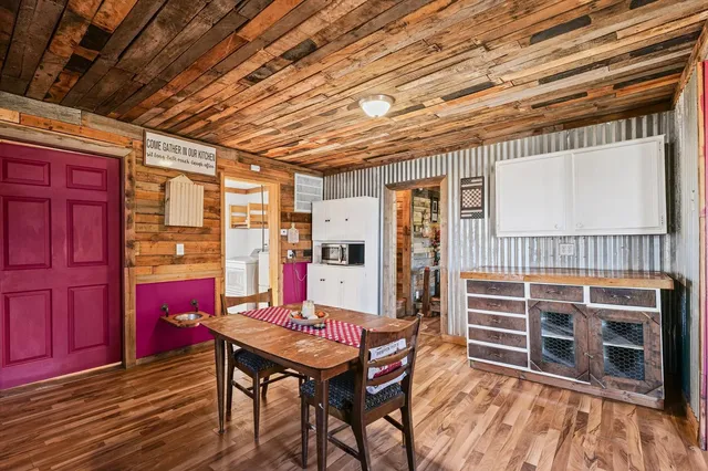 a room with furniture pool table and wooden floor