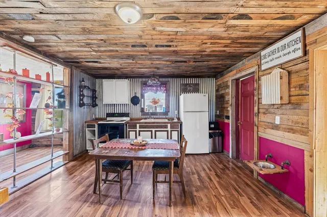 a dining room with furniture and wooden floor