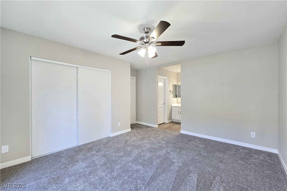 1812 North Decatur Boulevard, Unit 202 Las Vegas, NV 89108 - Photo 12 of 22 Primary Suite features a Ceiling Fan, New Sliding Glass Door to Balcony, and Bathroom with Dual Sinks, Tub/Shower Combination, and LVP Flooring