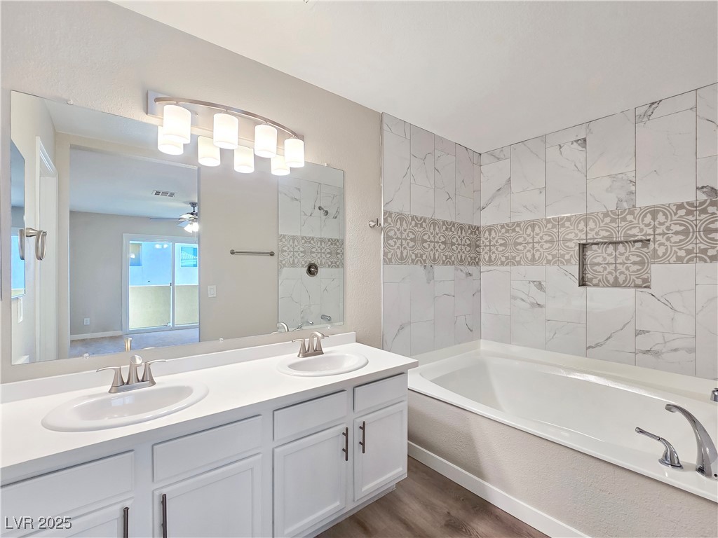 1812 North Decatur Boulevard, Unit 202 Las Vegas, NV 89108 - Photo 13 of 22 Bathroom with Dual Sinks, Tub/Shower Combination, and LVP Flooring