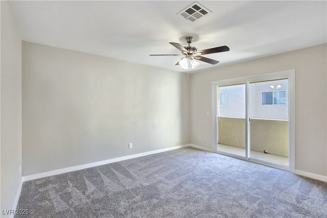 1812 North Decatur Boulevard, Unit 202 Las Vegas, NV 89108 - Photo 10 of 22 Primary Suite features a Ceiling Fan, New Sliding Glass Door to Balcony, and Bathroom with Dual Sinks, Tub/Shower Combination, and LVP Flooring