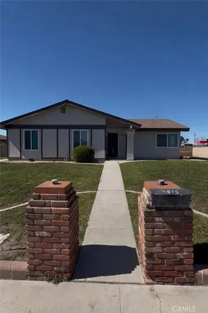 a large brick building with a yard in front of it