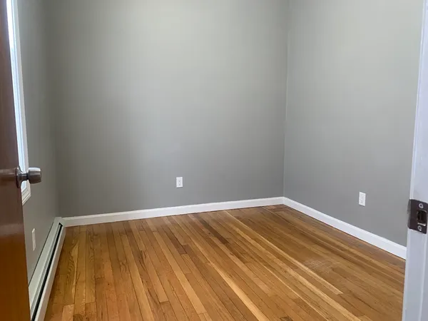 a view of a room with wooden floor