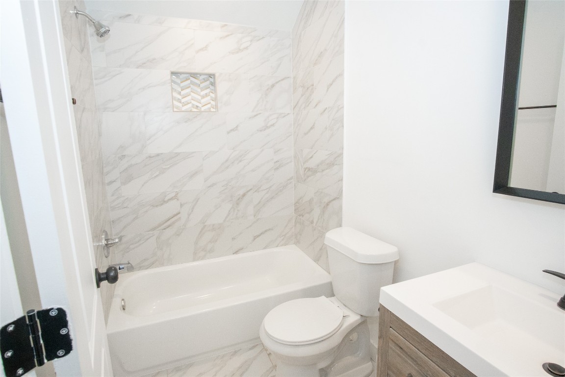 4423 Coyle Street Houston, TX 77023 - Photo 15 of 26 a white toilet sitting next to a bath tub