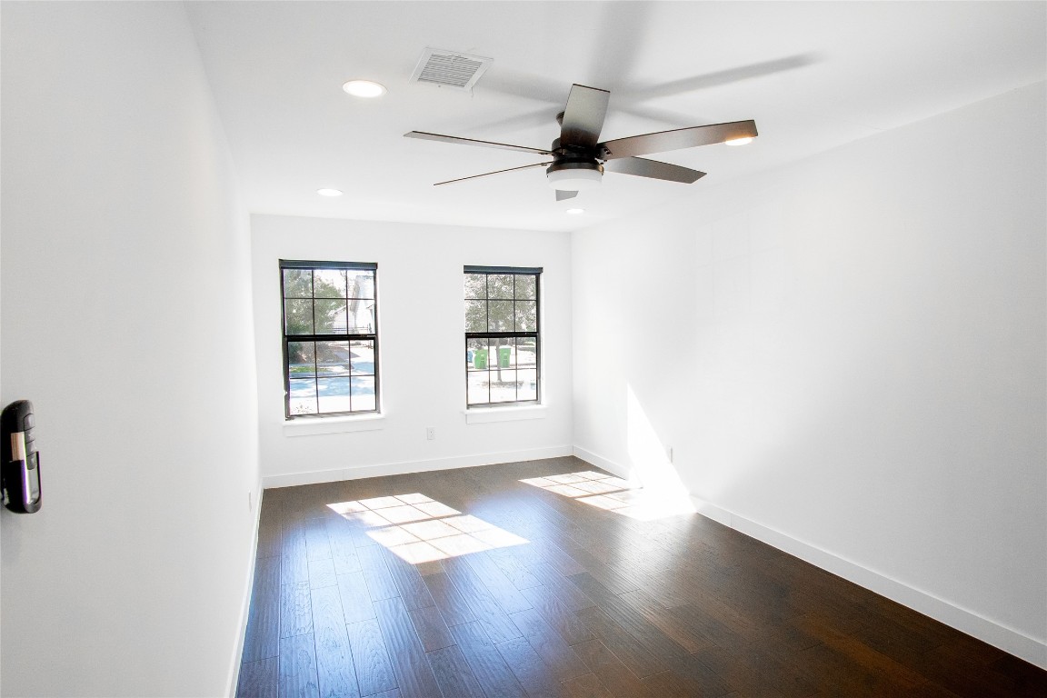 4423 Coyle Street Houston, TX 77023 - Photo 10 of 26 an empty room with wooden floor fan and windows