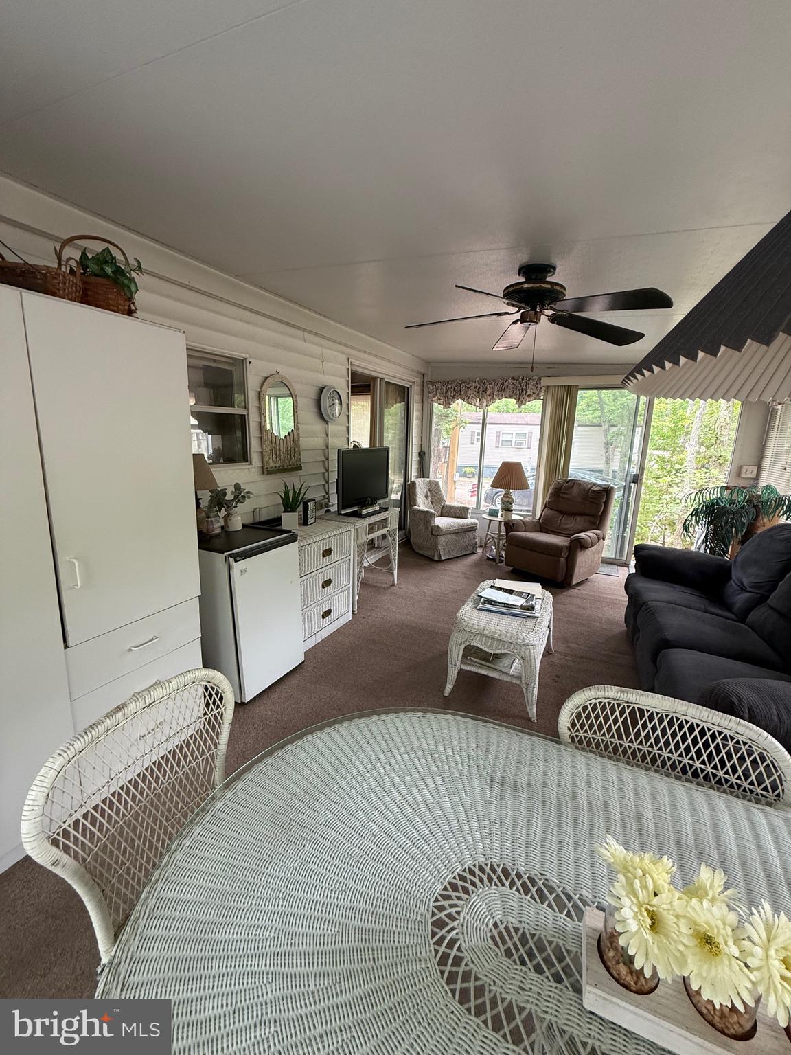 3066 Highway 9, Unit 196 Ocean View, NJ 08230 - Photo 4 of 8 a living room with furniture and a flat screen tv