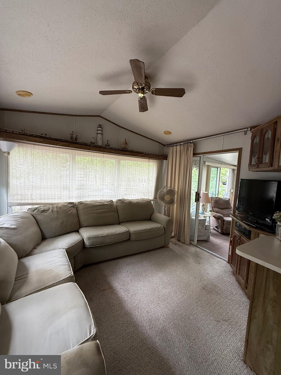 3066 Highway 9, Unit 196 Ocean View, NJ 08230 - Photo 5 of 8 a living room with furniture and a flat screen tv
