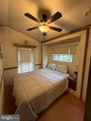 a bedroom with a bed and a large mirror