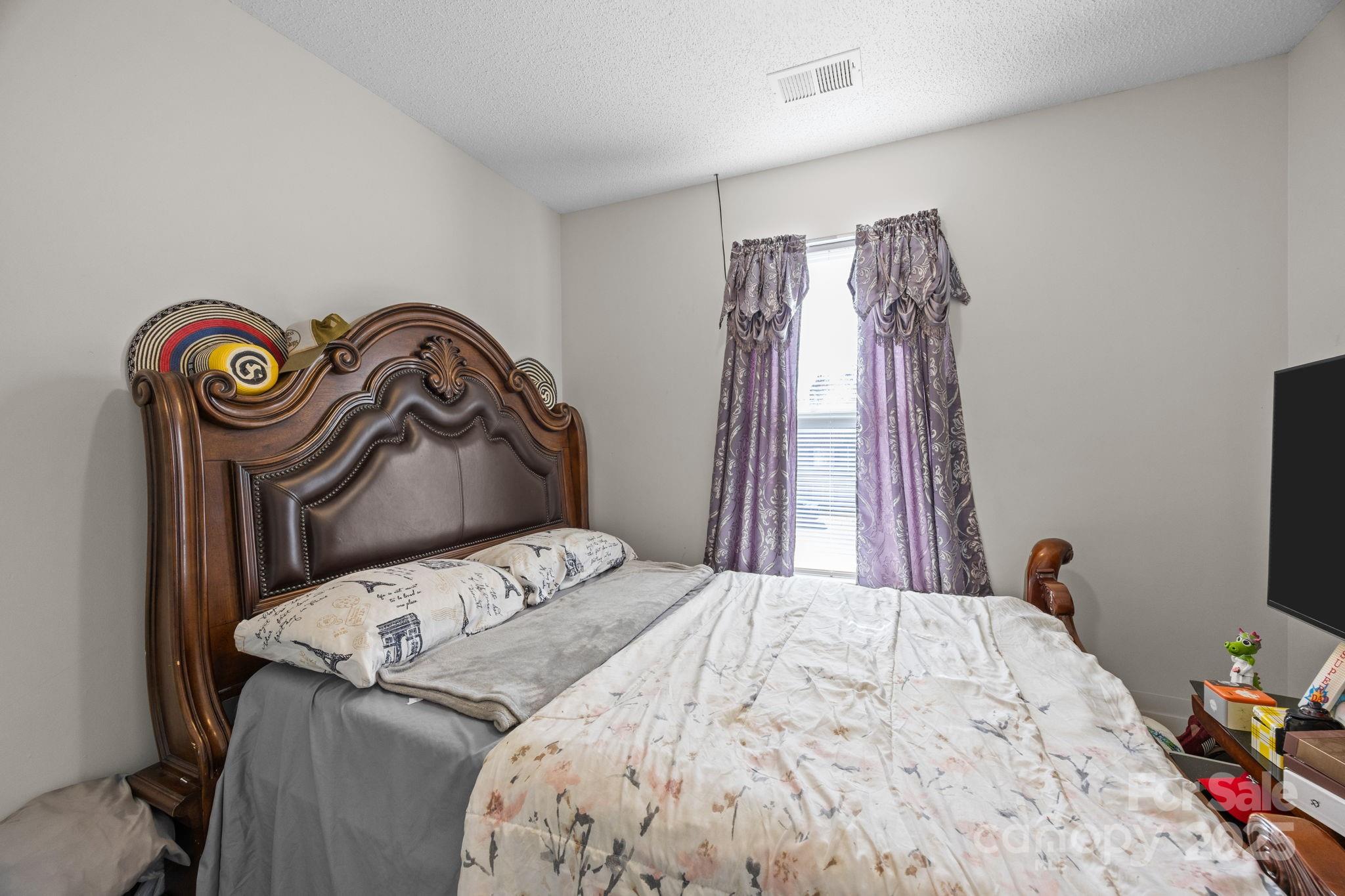 708 Raindrops Road Gastonia, NC 28054 - Photo 9 of 28 a bedroom with a bed and a window