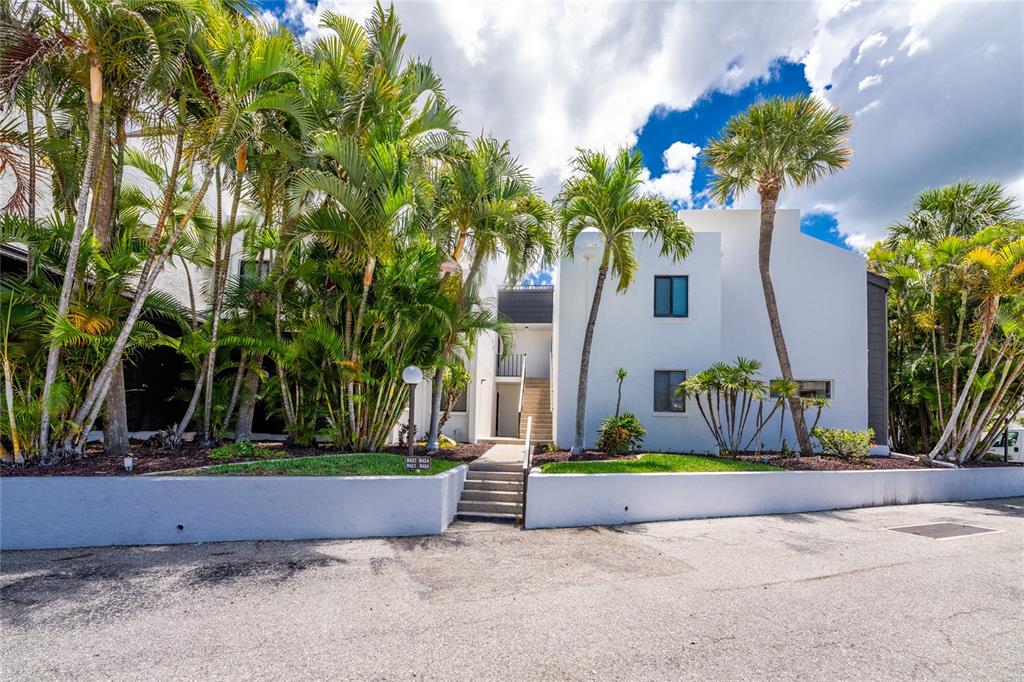 2955 North Beach Road, Unit B614 Englewood, FL 34223 - Photo 2 of 67 a house with palm tree in front of it