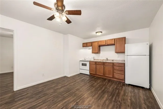 a kitchen with stainless steel appliances a refrigerator and a stove top oven