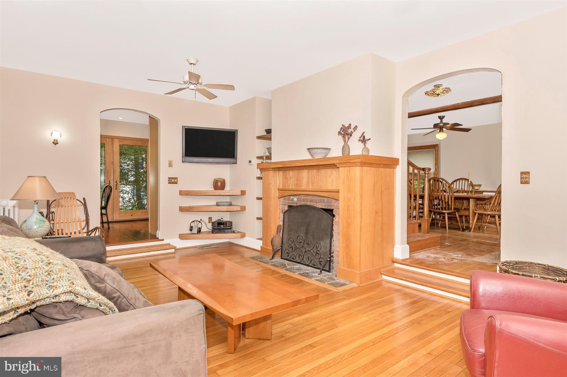 107 Sunnyside Road Silver Spring, MD 20910 - Photo 15 of 26 a living room with furniture a flat screen tv and a fireplace