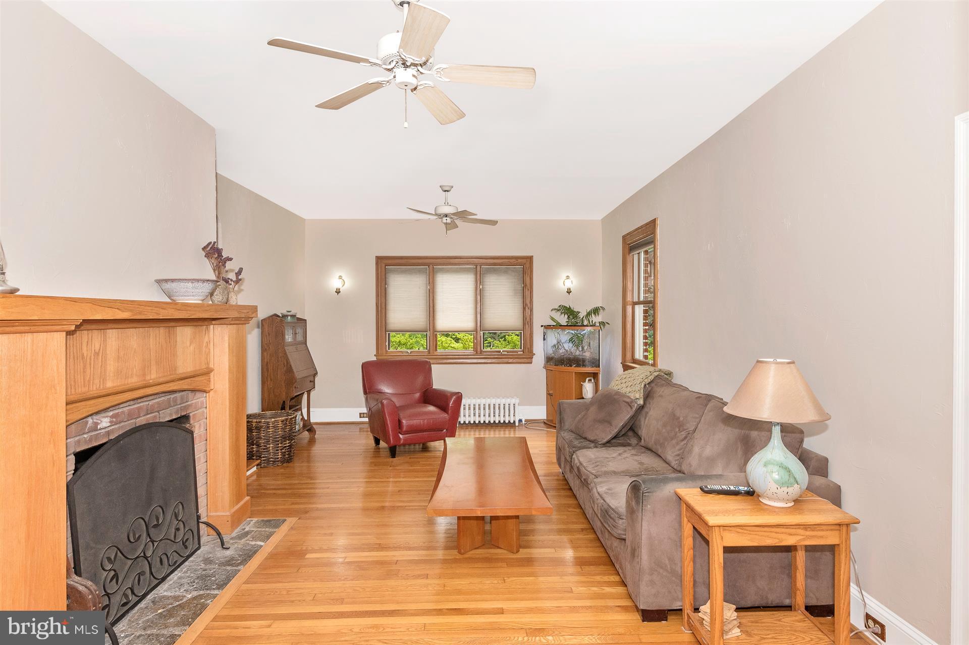 107 Sunnyside Road Silver Spring, MD 20910 - Photo 18 of 26 a living room with furniture a fireplace and a chandelier