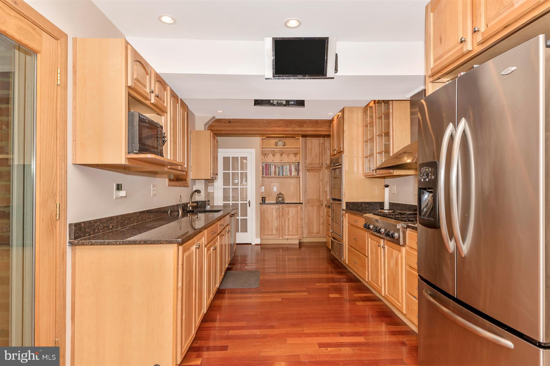 107 Sunnyside Road Silver Spring, MD 20910 - Photo 8 of 26 a kitchen with stainless steel appliances granite countertop a refrigerator a stove and a sink