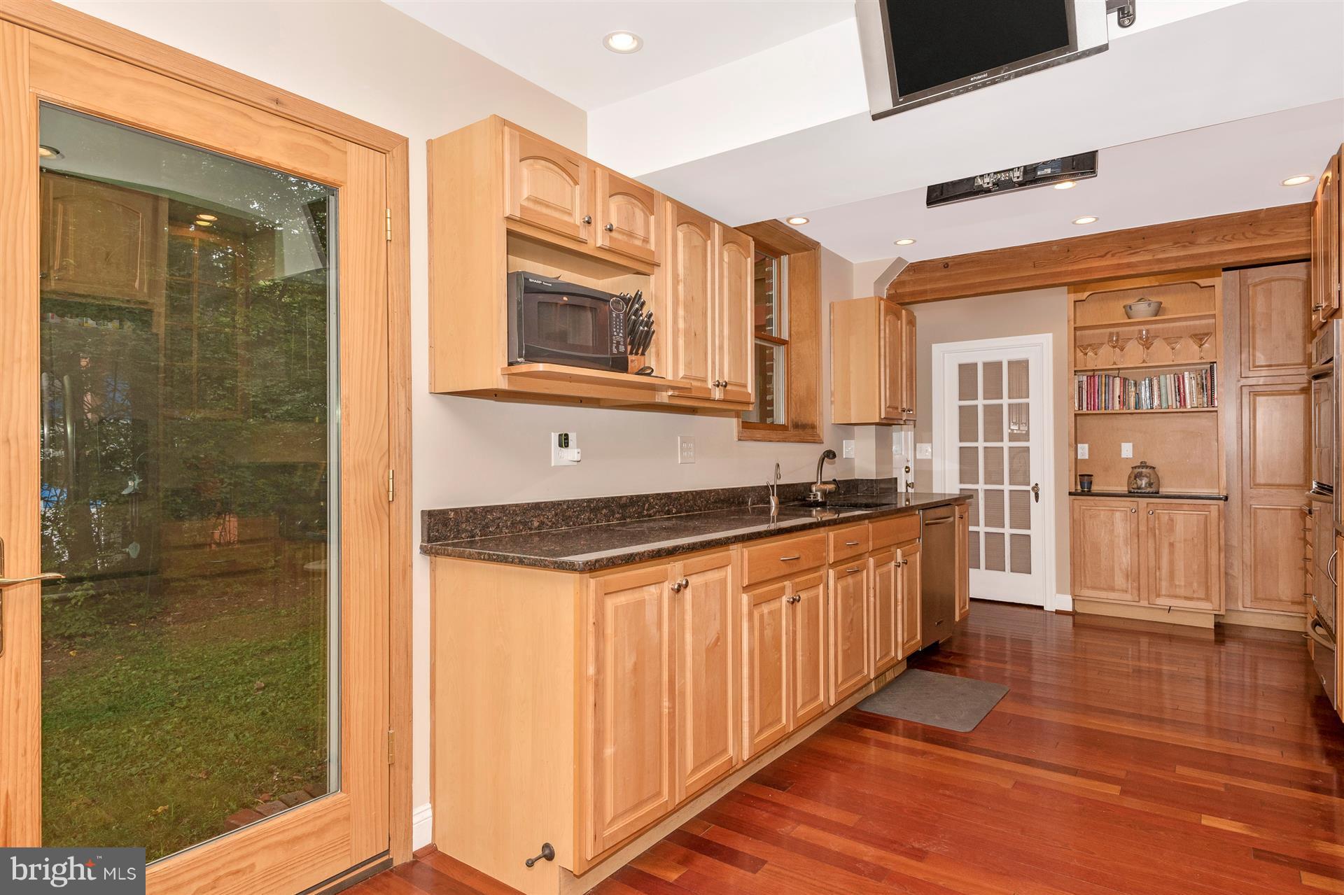 107 Sunnyside Road Silver Spring, MD 20910 - Photo 9 of 26 a kitchen with stainless steel appliances granite countertop a stove and a sink