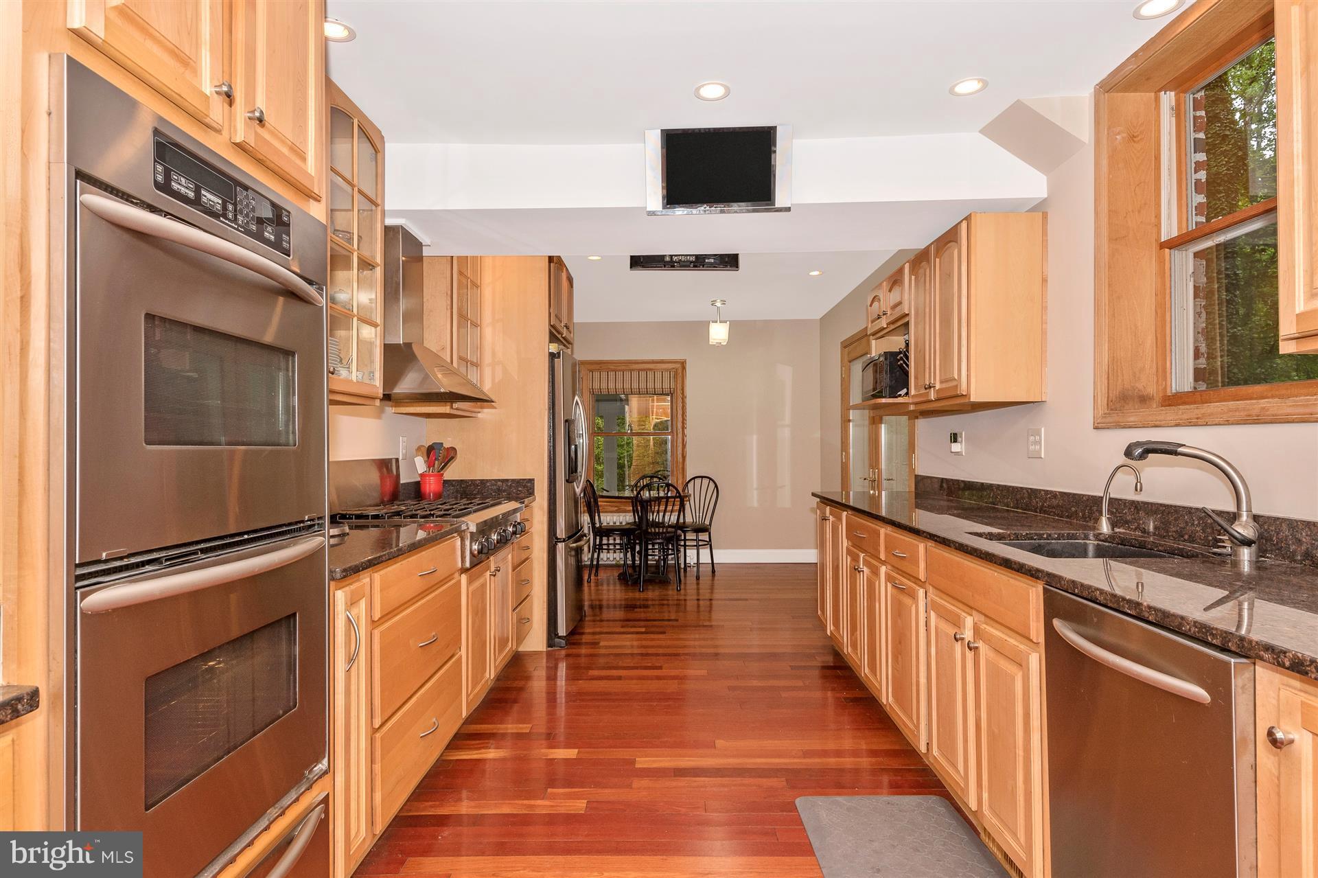 107 Sunnyside Road Silver Spring, MD 20910 - Photo 10 of 26 a kitchen with granite countertop a sink appliances and cabinets