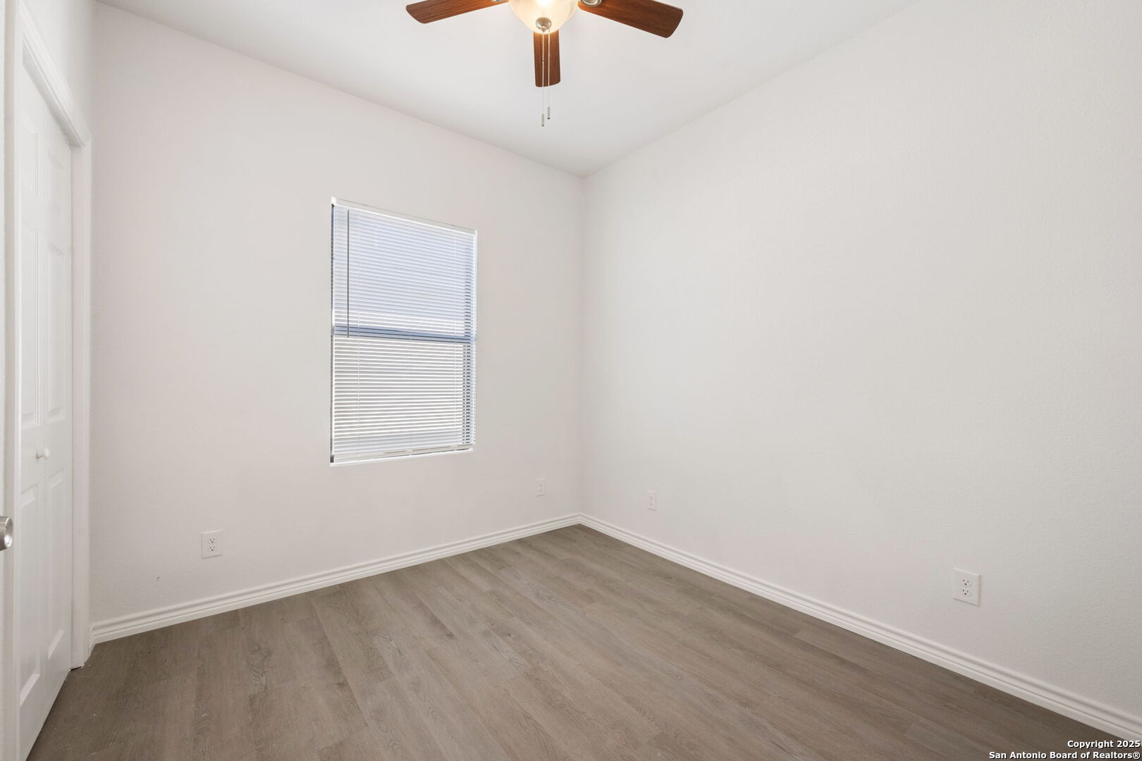 8719 Wurzbach Road, Unit 202 San Antonio, TX 78240 - Photo 13 of 18 an empty room with a window and a ceiling fan