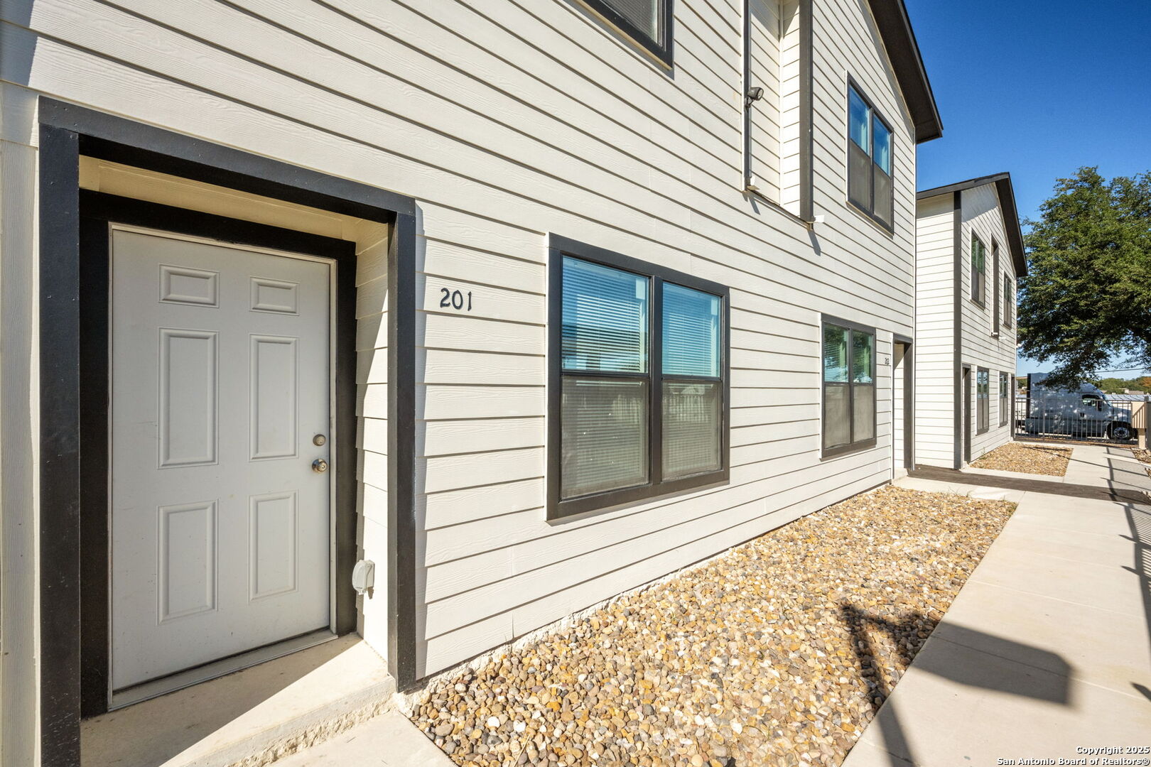 8719 Wurzbach Road, Unit 202 San Antonio, TX 78240 - Photo 15 of 18 a view of a house with a door and wooden walls